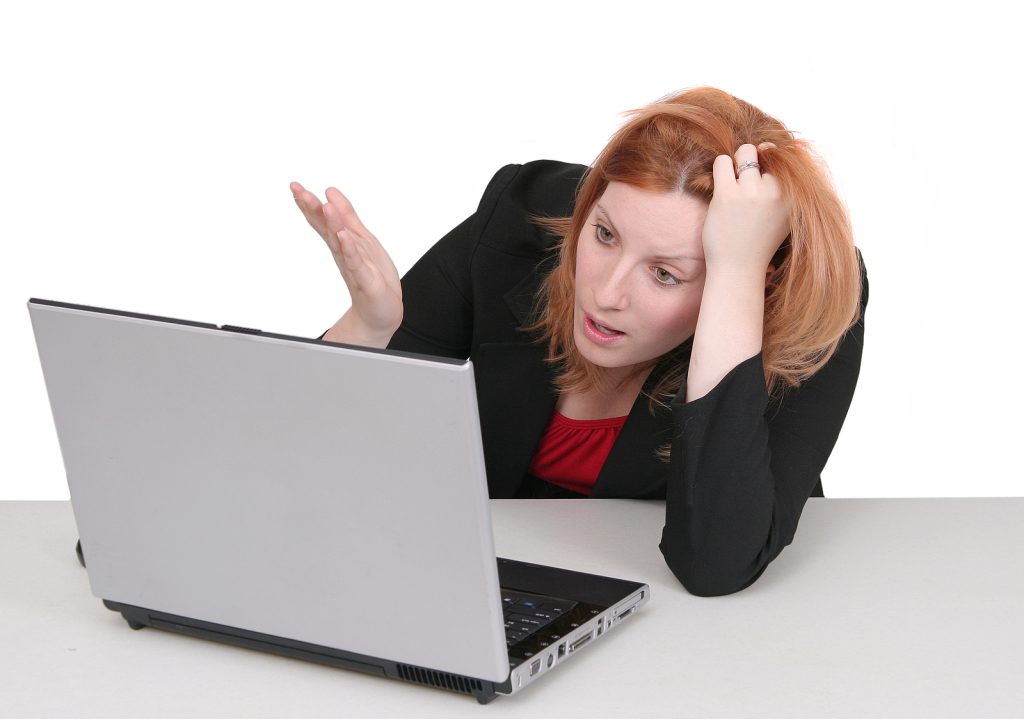 woman confused baffled looking at computer