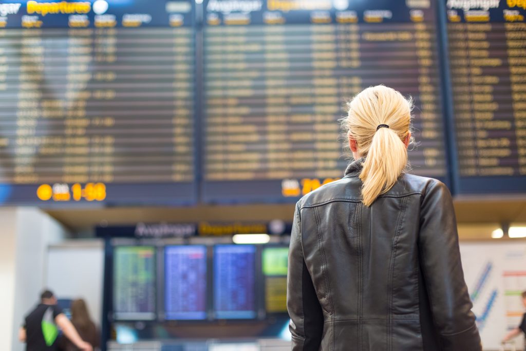woman traveller departures arrivals schedule airport